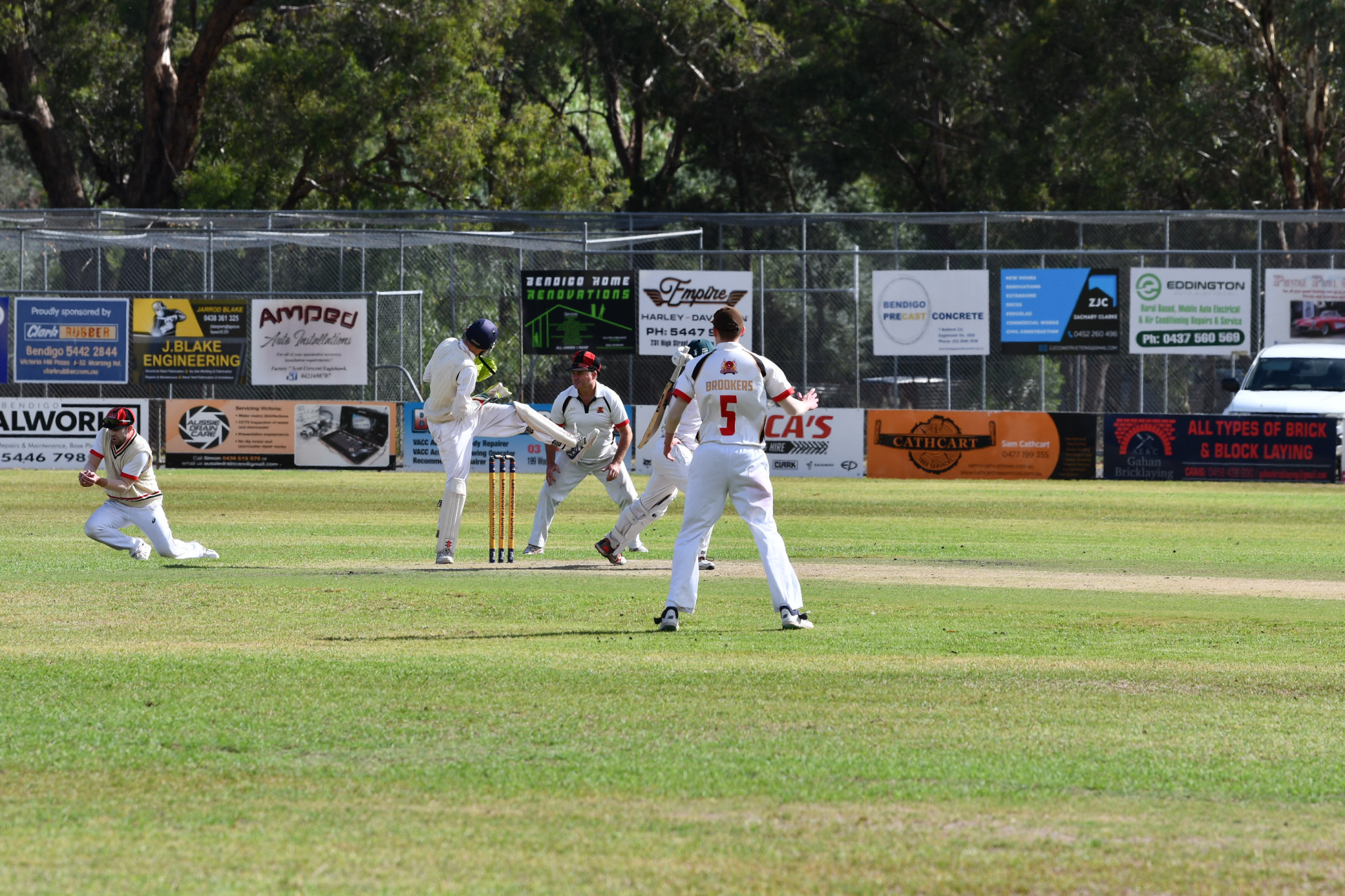With batter Thang Nguyen swarmed by fielders, Chris Lee snares the final catch for Carisbrook.