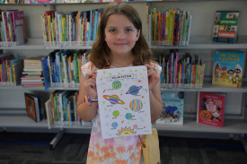 Freya Thoroughgood with her very colourful planets.