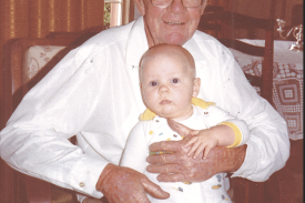 Arnold holding his eight-month-old grandson Scott Gregory.