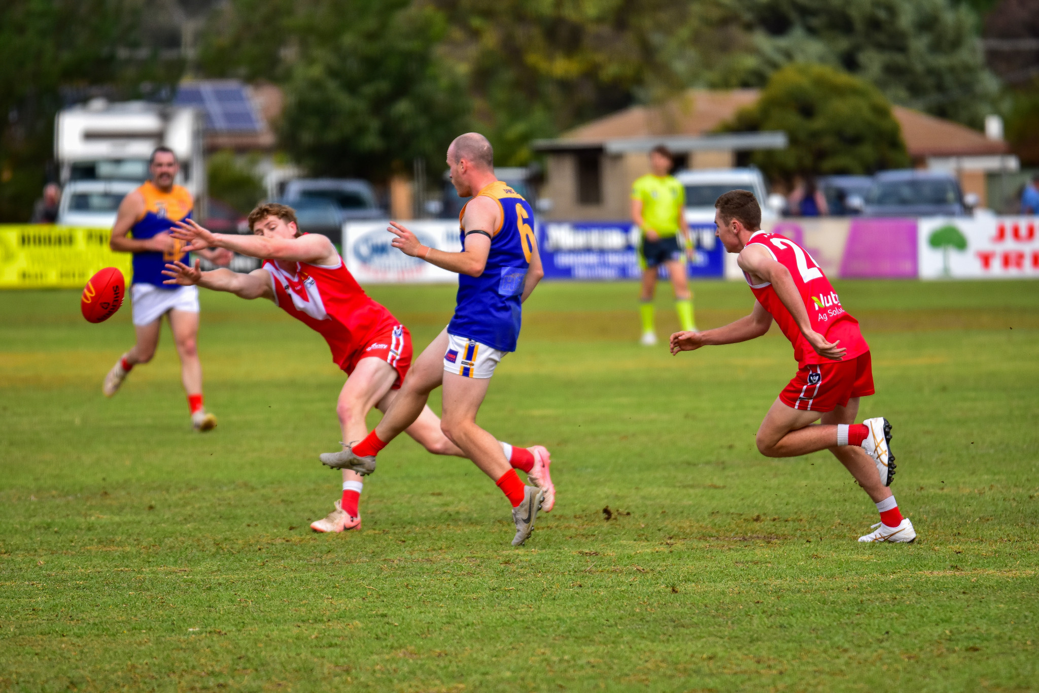 Dunolly’s Daniel Trull gets the handball away as Natte’s Zac Polinelli lays a tackle.