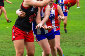 Olivia Butler gets a handball away for the Redbacks.