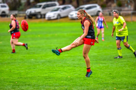 Olivia Rogers sends the ball forward after receiving a free kick.