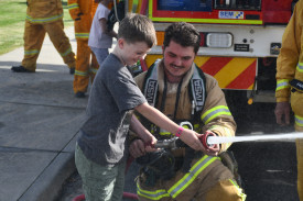 Nate was keen to have a go of the hose with Talbot firefighter Reed Smith’s help.