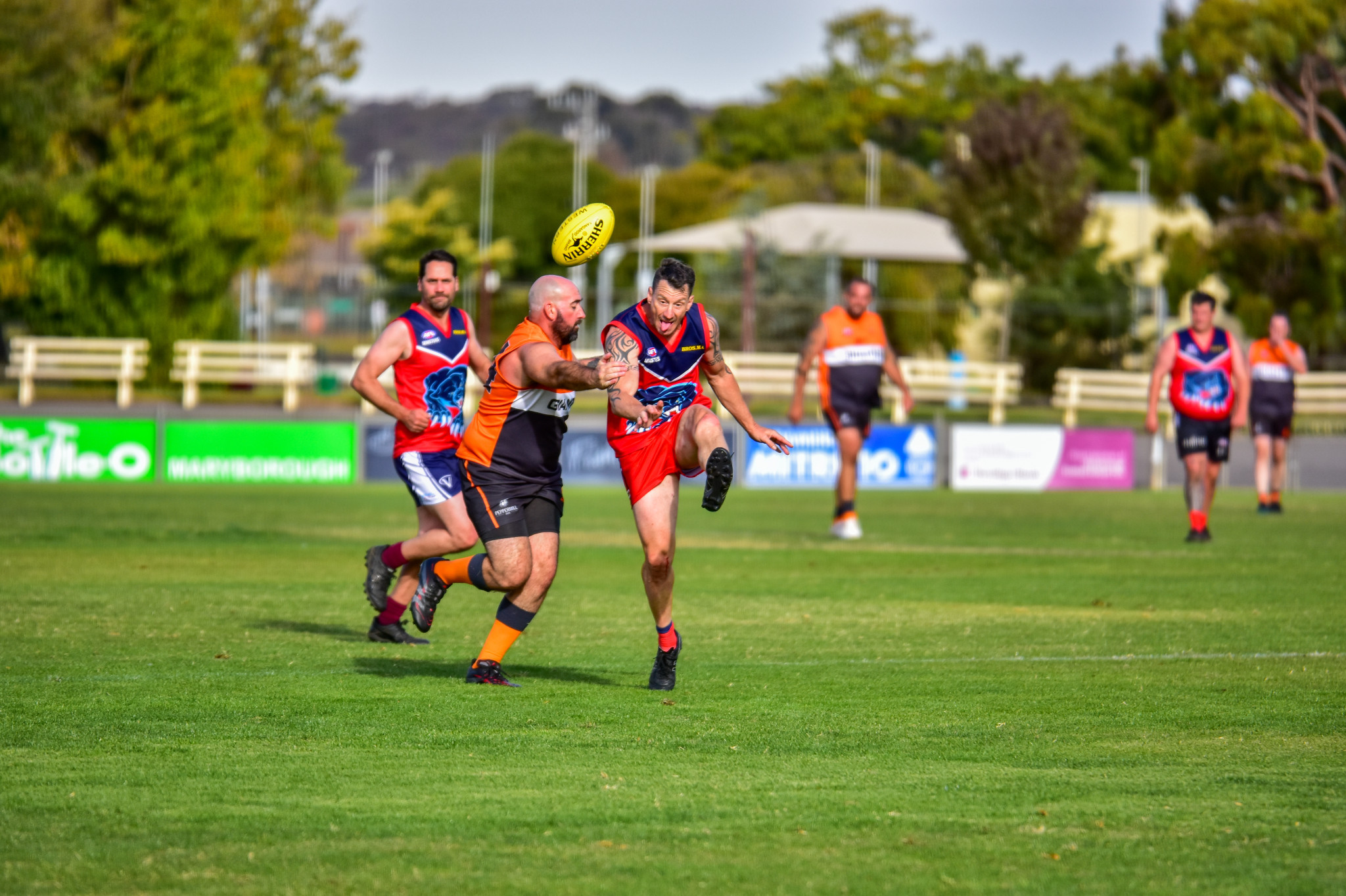 Nick Weaver sends the ball forward under heavy pressure.