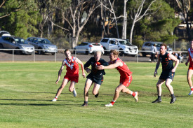 Giants’ Matt Walker tries to run through the tackle of Nathan Holt.
