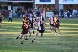 Talbot’s Jayson Atkins aims to escape the pressure of Ryder Henchie.