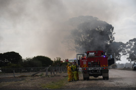 A number of firefighters donned breathing apparatus in order to control the structure fire.