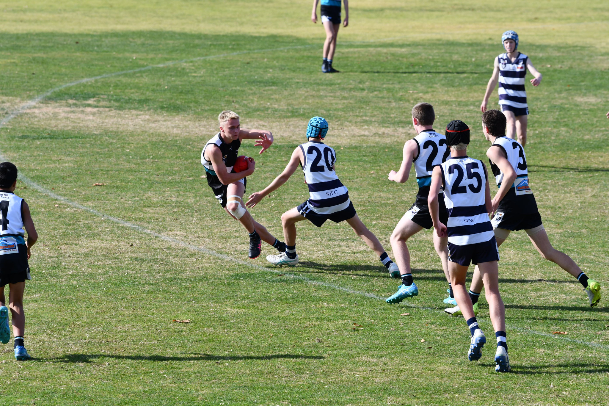 Aiden Collicoat lines up a stiff arm in the Maryborough Magpies heartbreaking one-point loss to Strathfieldsaye in the under 16s.