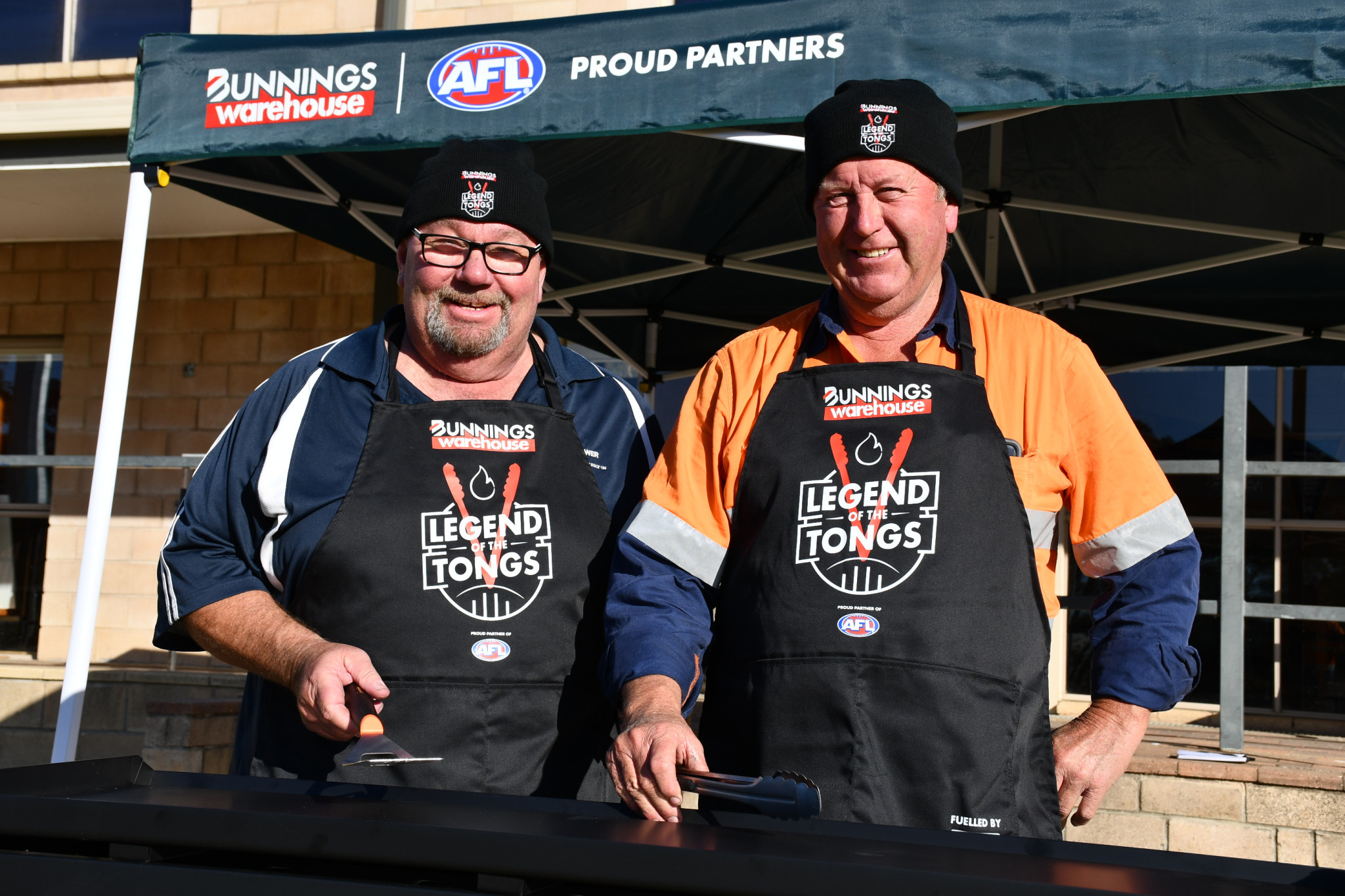 Harcourt FNC volunteers Gary Selwood and Buzz Nunn are sizzling with excitement for the club’s new barbecue and pop-up marquee donated by Bunnings.