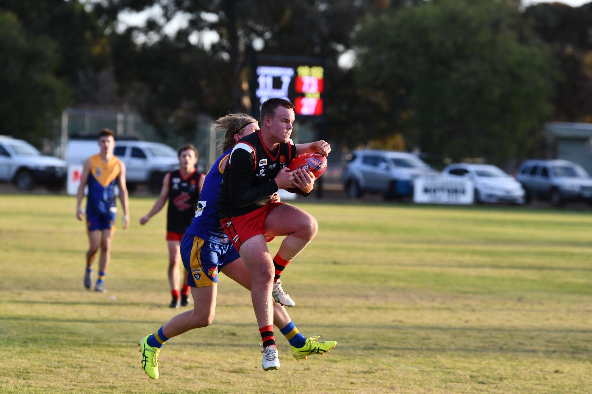 The MCDFNL is starting to heat up on the football field, with Carisbrook’s Lachlan Bursill and Harcourt’s Orin McKay one of countless players giving it their all.
