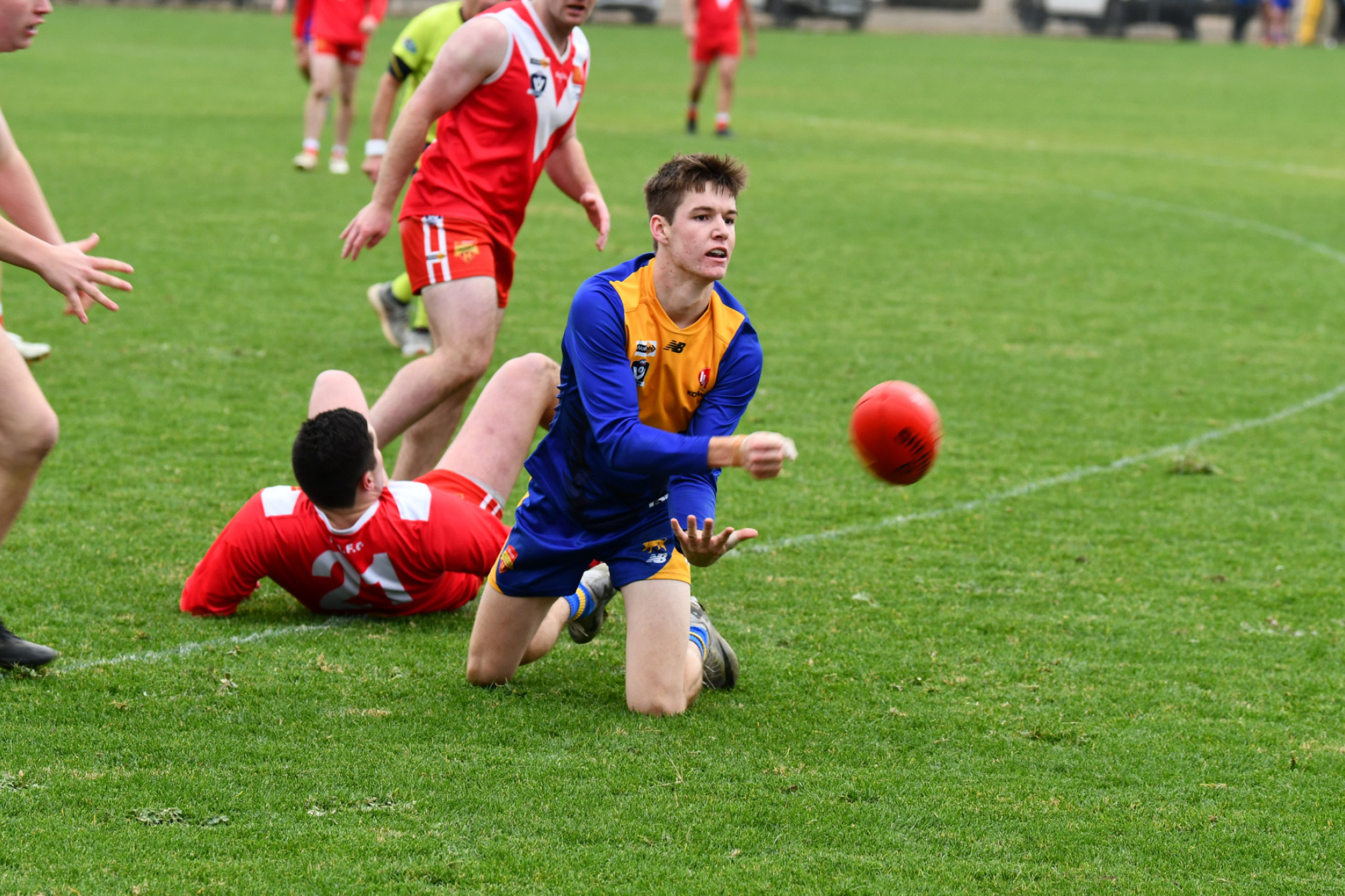 Jack Threlfall escapes danger and gets off a handball for Harcourt.