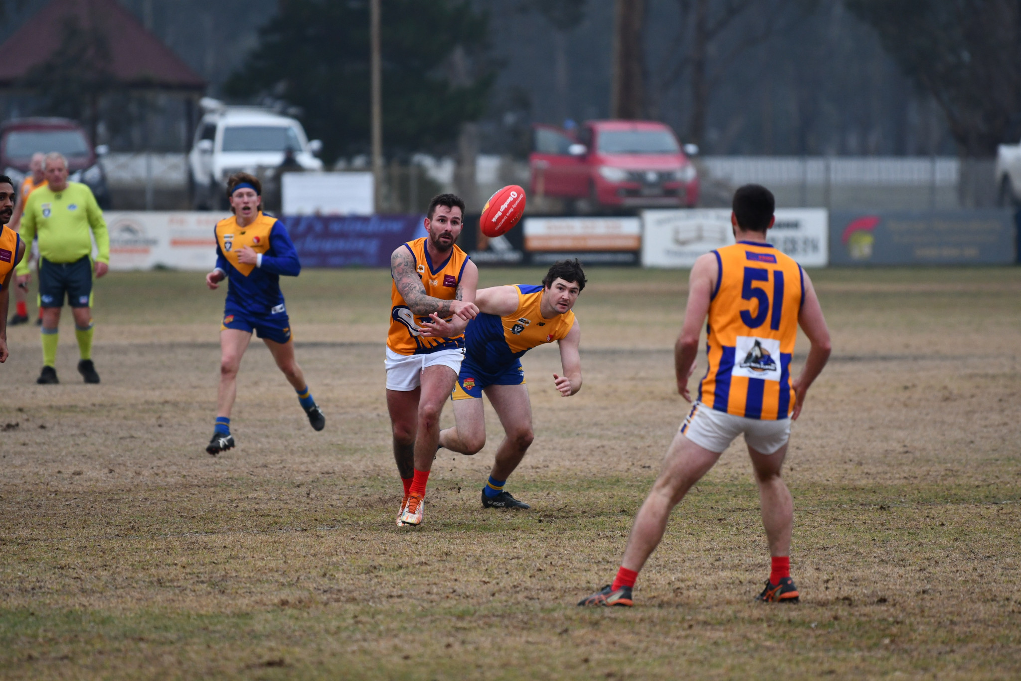 Justin Allison handballs out of danger in Dunolly’s loss to Harcourt. 240625 20