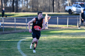 Atticus Cullinan surveys the field as he looks to get the ball out of the backline.