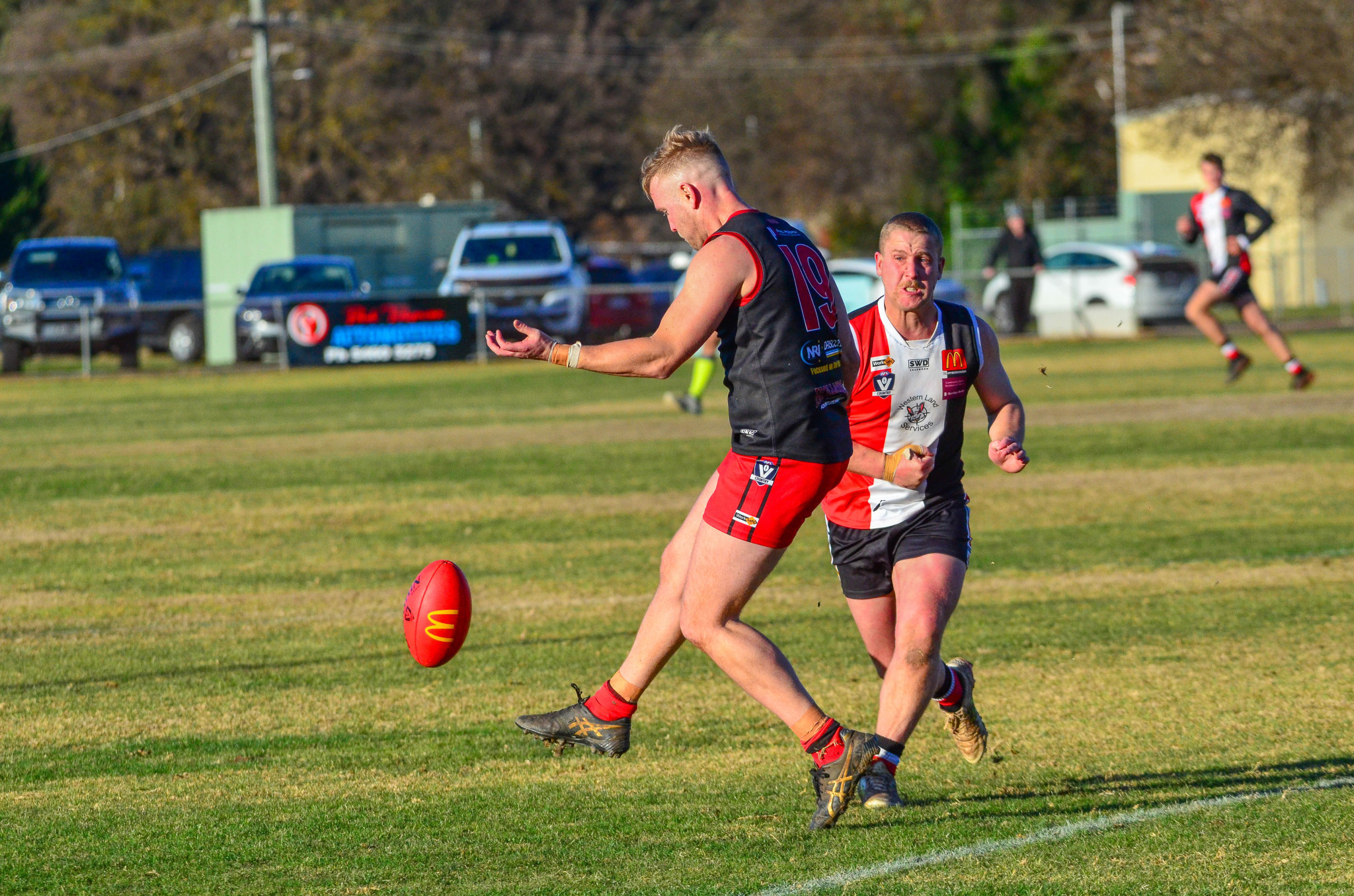 Carisbrook recruit Harry Whitty gets the ball away just in time.