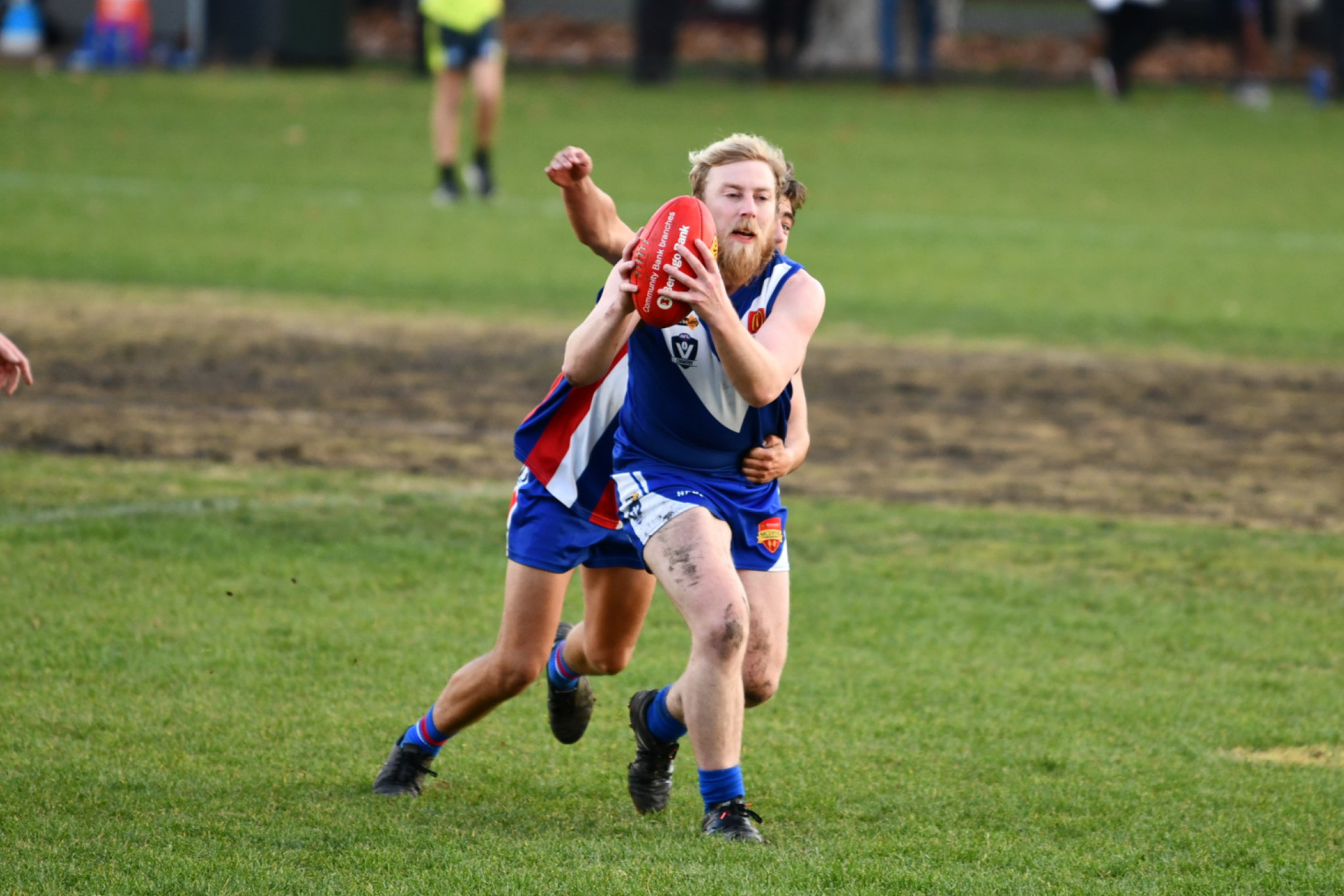 Geordie McMurtrie tries to get a handball away before being tackled.