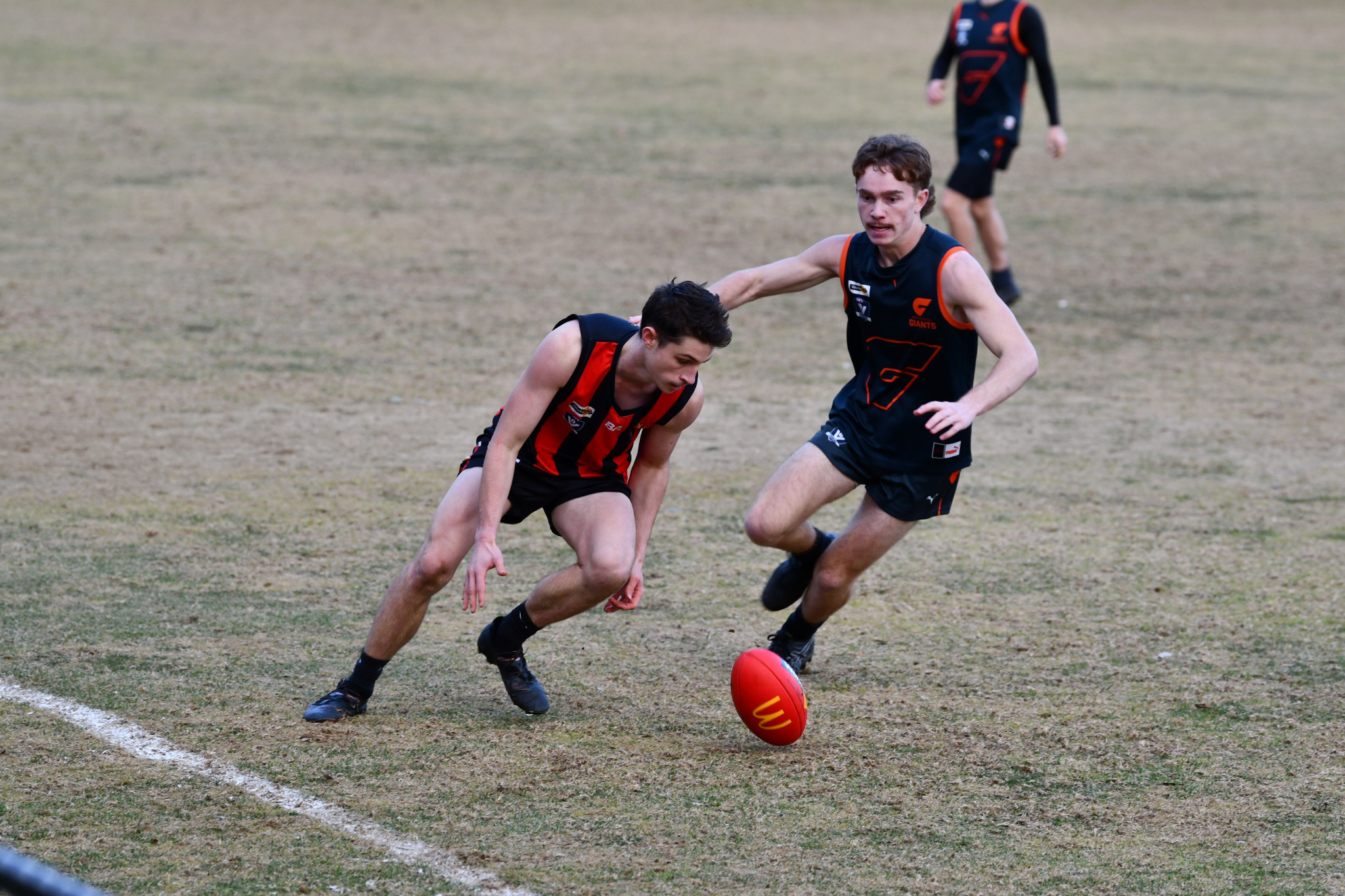 Maldon’s Thomas Maxwell and Maryborough’s Ronnie Feeney contest the ball near the boundary line.