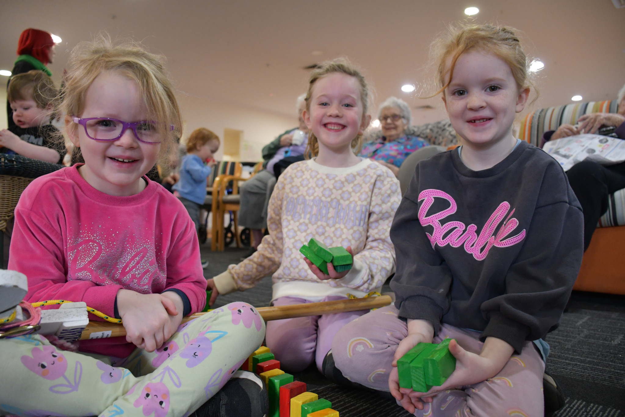The collaborative effort of three community organisations to bring handmade wooden toys to Havilah’s intergenerational playgroup quickly brought smiles to the faces of Liv Carroll (centre) alongside Charlotte and Madison Fary.