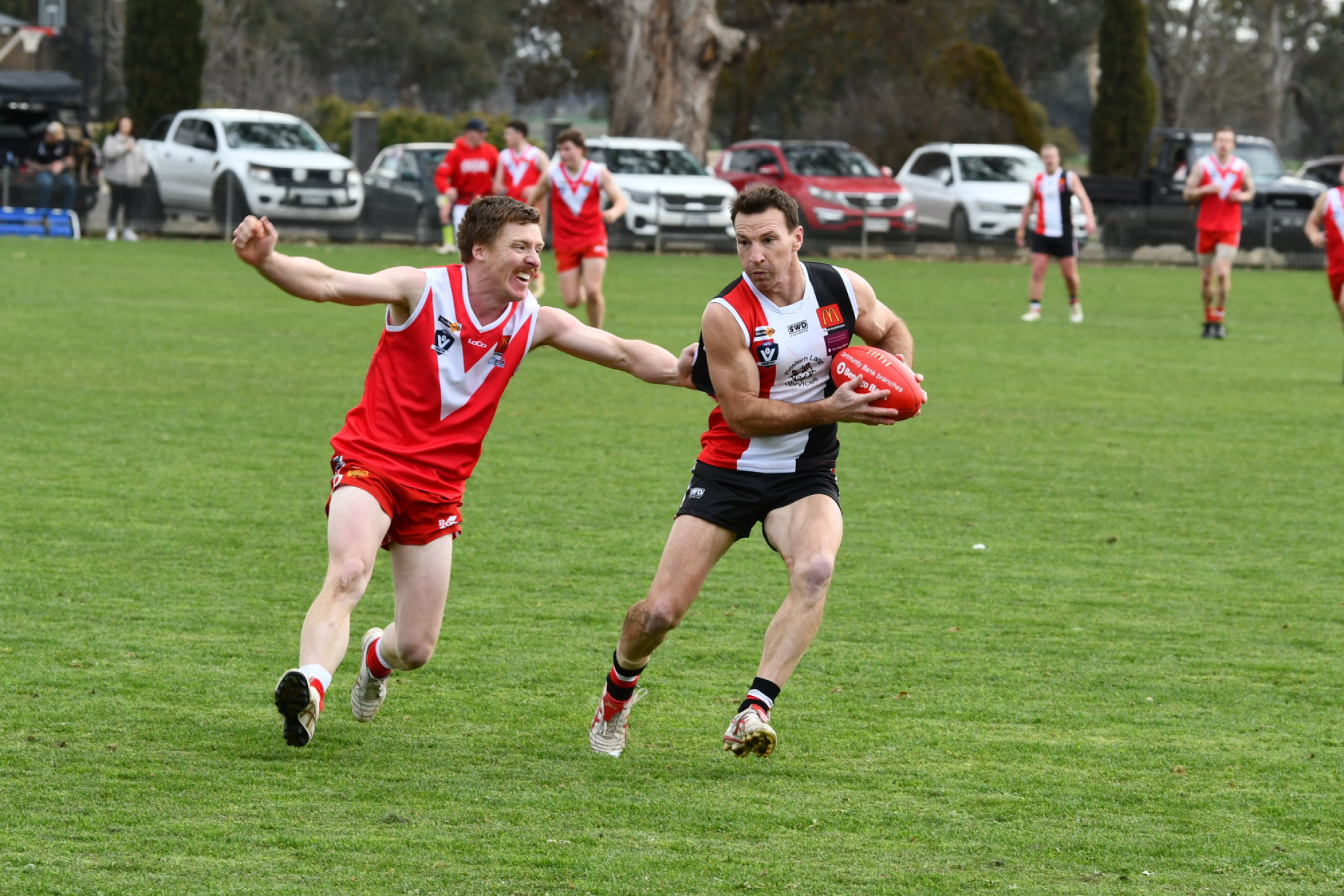AFL legend Brent Harvey looks to shake away from Natte’s Toby Beavis in his second game for Trentham.