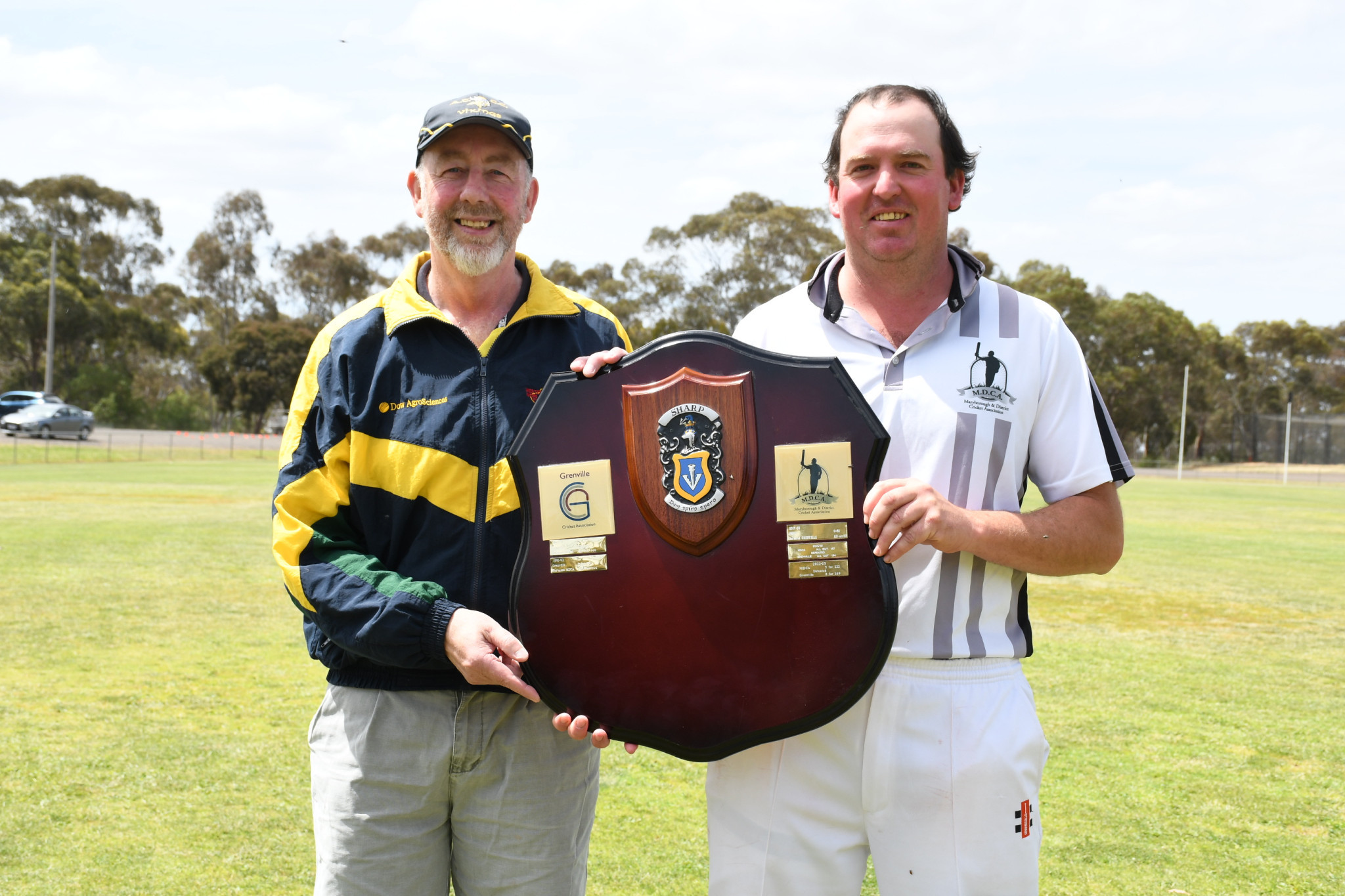 Terry Sharp hands the shield named in his honour to winning captain Sam Bartlett after the MDCA&rsquo;s dominant eight-wicket win on Sunday.