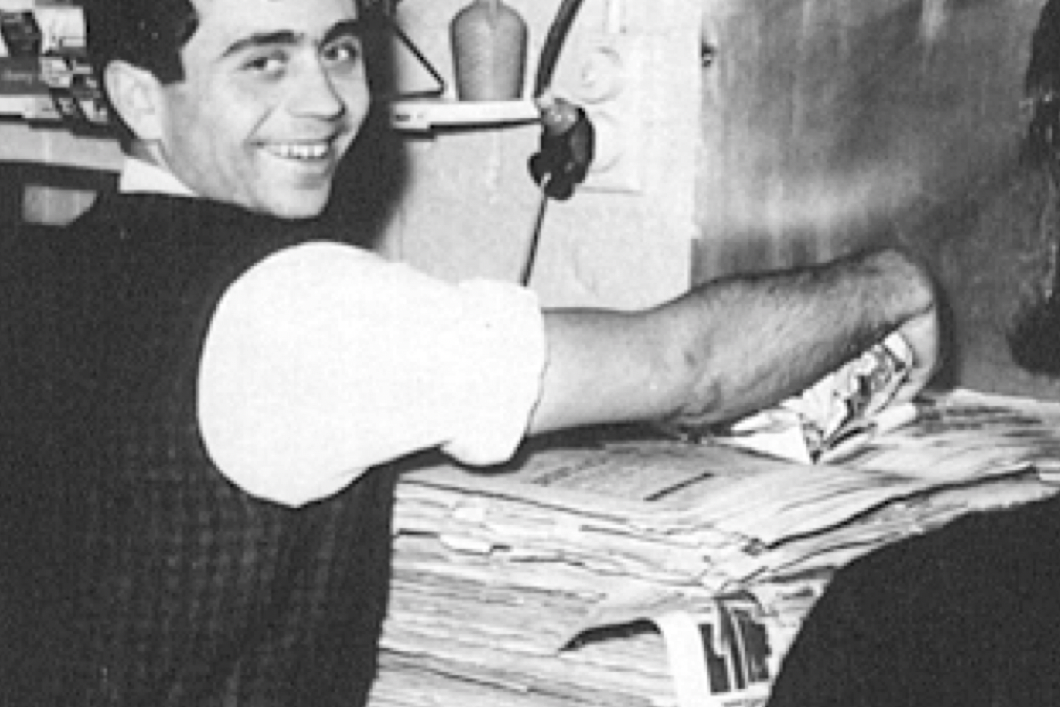 Billy wrapping fish and chips in newspaper.