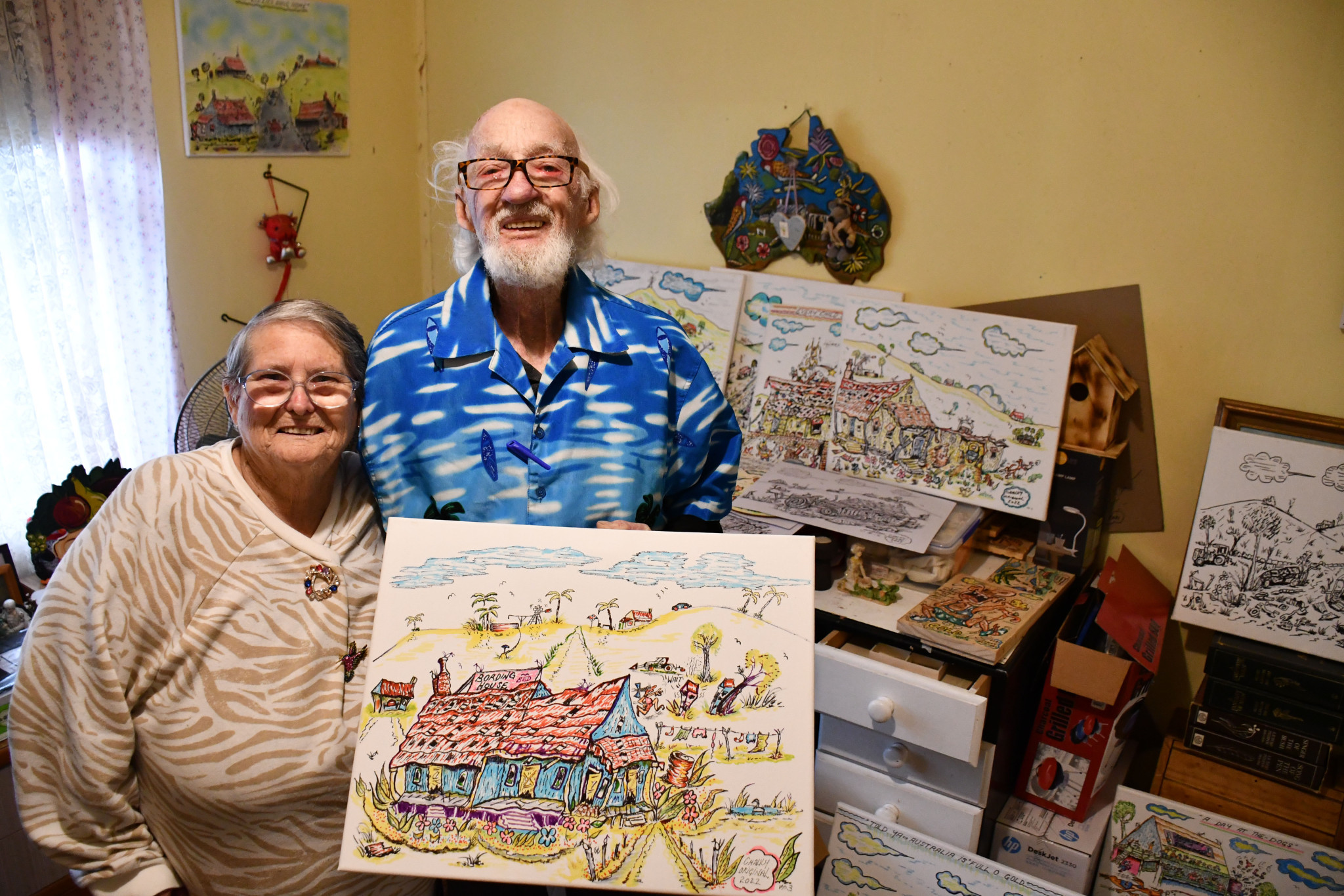 Chalky and his partner Joyce Le Fevre with his many pieces of artwork.